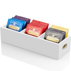 three different types of tea bags in a white box