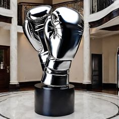 a sculpture of a pair of boxing gloves on top of a marble floor