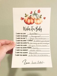 a person holding up a card that says wake for baby with pumpkins on it