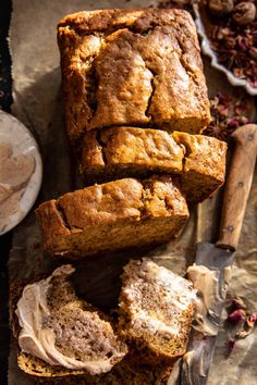 sliced loaf of banana bread sitting on top of a cutting board next to a knife