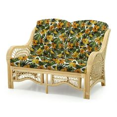 a wicker couch with yellow flowers and green leaves on the back, against a white background