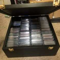 an open black briefcase filled with cd's