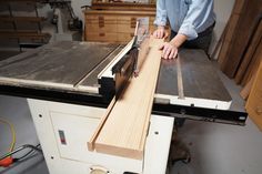 a person using a table saw to cut wood