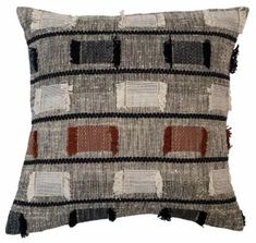 a gray and brown pillow with squares on it