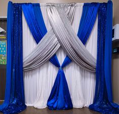 blue and silver drapes are hanging on the wall