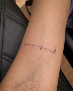 a woman's arm with the word peace is beautiful written on it, and in cursive font