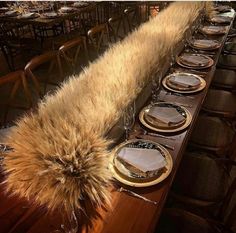 a long table is set with plates and silverware