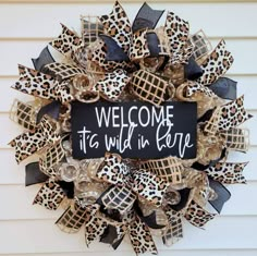 a leopard print wreath with the words, welcome to wild in life on it's side