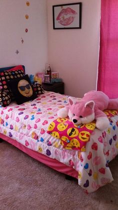 a bed with pink sheets and a teddy bear on it in a room that has carpeted flooring