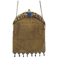 Wonderful, large 1920's Czech Jeweled Mesh Purse of the largest scale and finest quality relined by famed, Art Bag of Madison Ave. NY. Jeweled frame with faux lapis pate de verre molded cameo of Egyptian kings with large gilt lions, collet set pastes, mother of pearl plaques and glass pearls throughout. Incredible chain mesh links form the body of the bag. Chain has been added for use on shoulder as well. Handmade pate de verre drops line the bottom of the bag. This is the largest and finest exa Art Deco Textiles, Jewel Frames, Vintage Evening Bags, Bling Bags, Art Bag, Beaded Purses, Vintage Purses, Mesh Bag, Beaded Bags