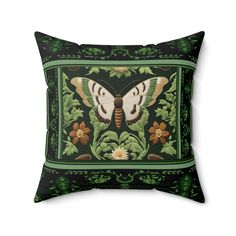 a green and black pillow with a butterfly on it