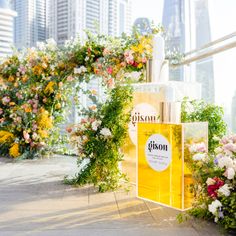 an outdoor display with flowers and perfume bottles