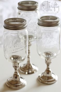 three mason jars with lids are sitting on a table