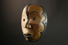 a wooden mask on a black background