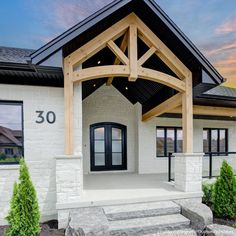 the front entrance to a home with stone steps leading up to it's entry