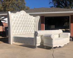 a white couch sitting in front of a house