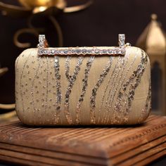 👛 Our Gold wedding clutch for bride is an elegant addition to your big day . This stunning gold sequin and thread embroidered clutch is ideal for any special occasion. The clutch bag is embellished with intricate embroidery. The clutch bag is closed with a designer snap. It is the ideal size for carrying your essentials like your phone, wallet, and keys. ✅ FEATURES: ⦿ Made using sequin embroidery. ⦿ Perfect accessory for any event ⦿ Adds a touch of luxury.  ⦿ Vibrant and eye-catching ✅ SPECIFIC Luxury Gold Embroidered Clutch For Festivals, Luxury Gold Embroidery Wedding Clutch, Festive Sequined Bags For Reception, Luxury Hand-embellished Gold Bags, Luxury Hand Embellished Gold Bags, Glamorous Rectangular Sequined Evening Bag, Luxury Gold Hand Embellished Bags, Elegant Rectangular Sequin Clutch, Rectangular Gold Embroidered Evening Bag For Receptions