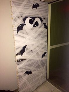 a door decorated to look like a bat with eyes and bats in the sky on it