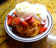 a plate with some ice cream and strawberries on it