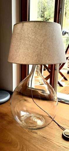 a glass lamp sitting on top of a wooden table