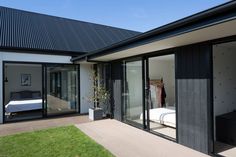 a bedroom with sliding glass doors on the side of it and a bed in the corner