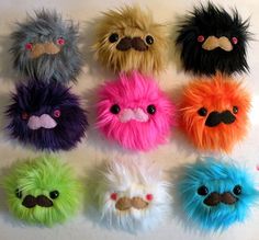 several different colored stuffed animals with mustaches