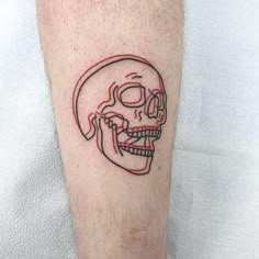 a man's leg with a red line drawing of a human skull on it