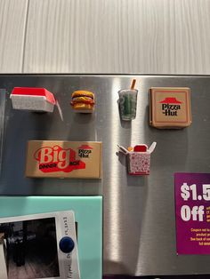 a refrigerator with magnets and food on the door for $ 5 off at big kraut