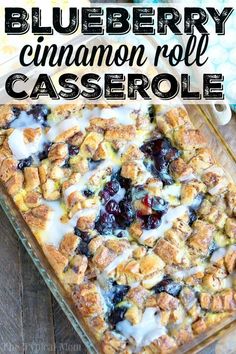 blueberry cinnamon roll casserole in a glass baking dish on a wooden table