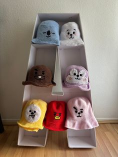 several hats are arranged on top of each other in the shape of an animal head