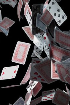 many playing cards are falling into the air