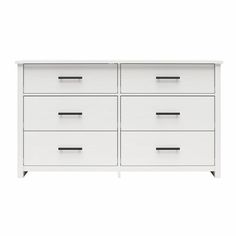 a white dresser with black handles and drawers