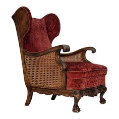 an old chair with red upholstered fabric and wooden frame, on white background