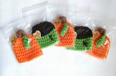 four small crocheted carrots in plastic bags