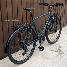 a bike parked next to a wooden fence with no wheels on it's front wheel