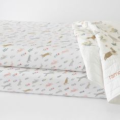 two sheets with animals on them are laying next to each other in front of a white background