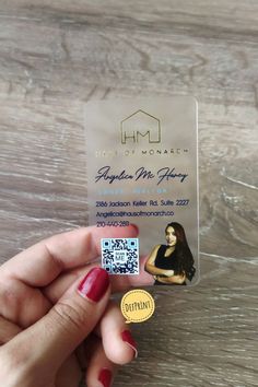 a person holding up a business card with a qr code on the front and side