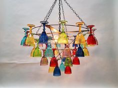 a chandelier with many colored glass bottles hanging from it