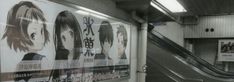 an escalator in a subway station with posters on the wall