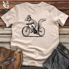 a t - shirt with a fish on the back of it and an image of a bicycle