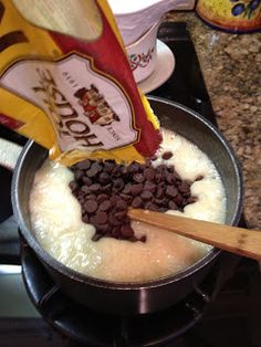 chocolate chips are being added to the batter in a skillet on the stove top