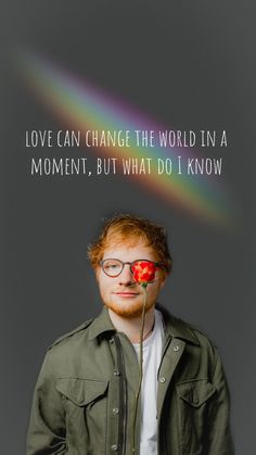 a man with glasses and a rose in his mouth is looking up at the camera