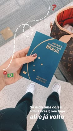 a person holding up a passport in their hand with the words brasi on it