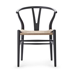 the wish chair is made from black wood and has a woven seat pad on it