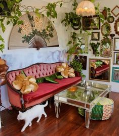 a living room filled with furniture and lots of plants