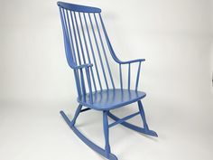 a blue rocking chair against a white background