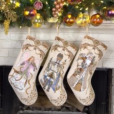 three christmas stockings hanging from a mantel