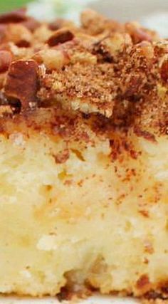 a close up of a piece of cake on a white plate with nuts and crumbs