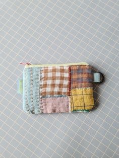 a small patchwork wallet sitting on top of a table