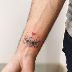 a person with a tattoo on their wrist holding the hand of another person's arm